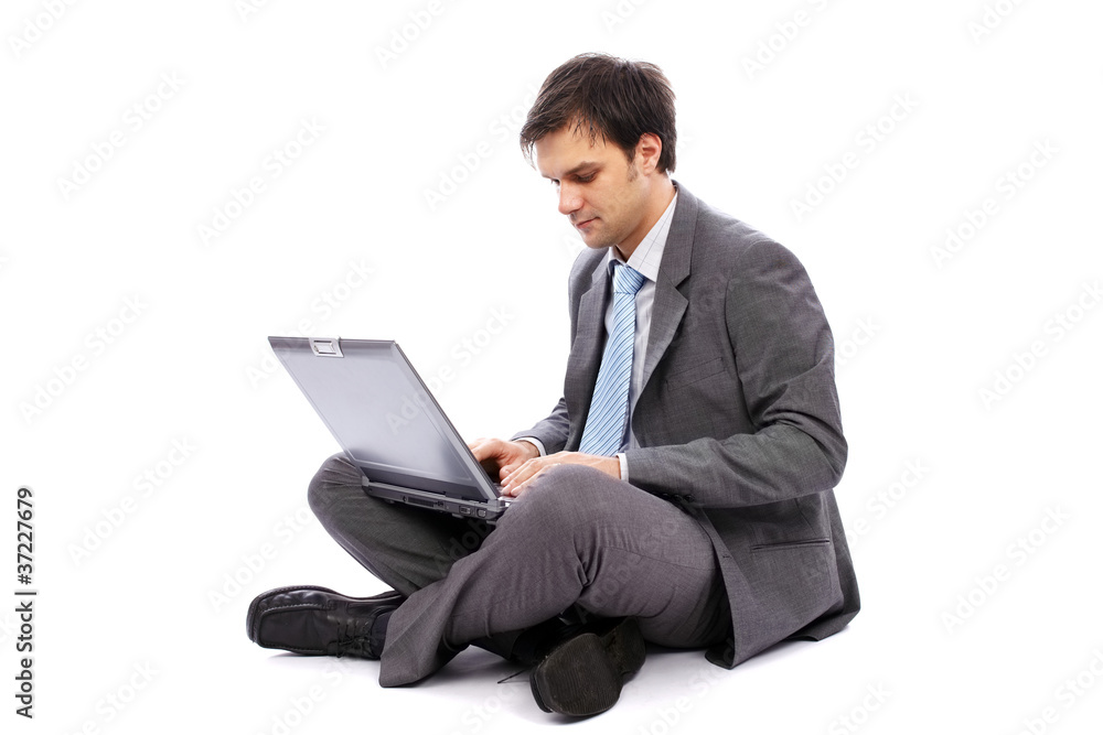 Young businessman typing on a laptop Young businessman typing on a laptop