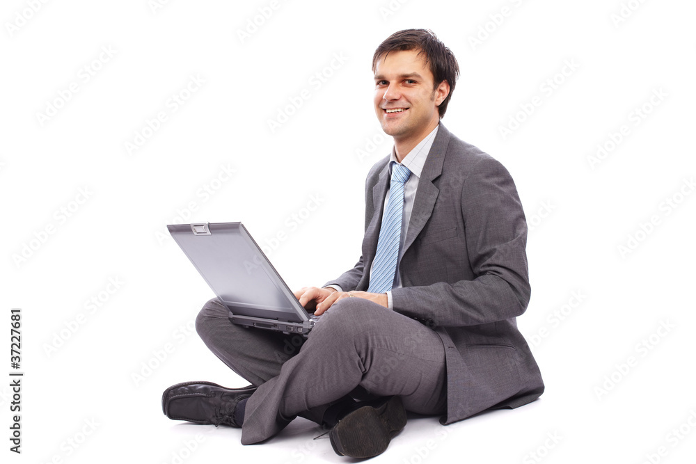 Young businessman typing on a laptop Young businessman typing on a laptop