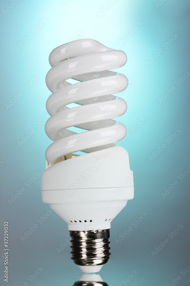 energy saving light bulb on blue background. energy saving light bulb on blue background.