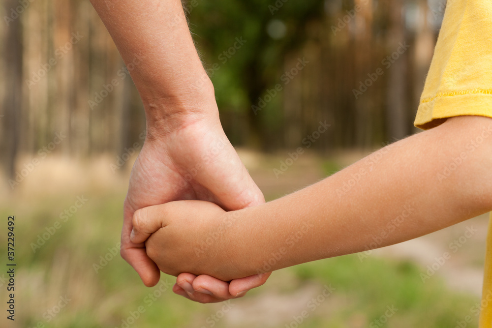 Mother holding a hand of his son Mother holding a hand of his son