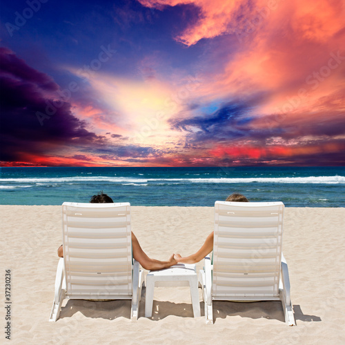 Honeymoon couple enjoy ocean sunset