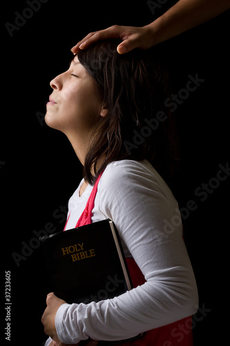 Hispanic Woman Being Blesses While Praying