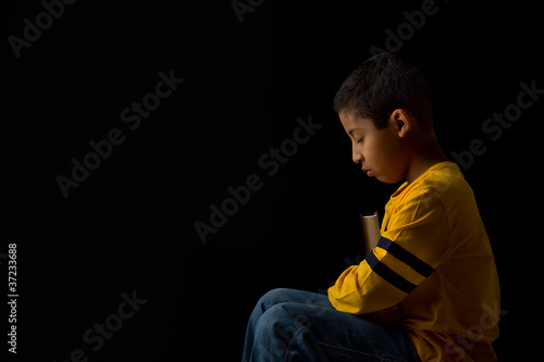 Child Praying with Bible