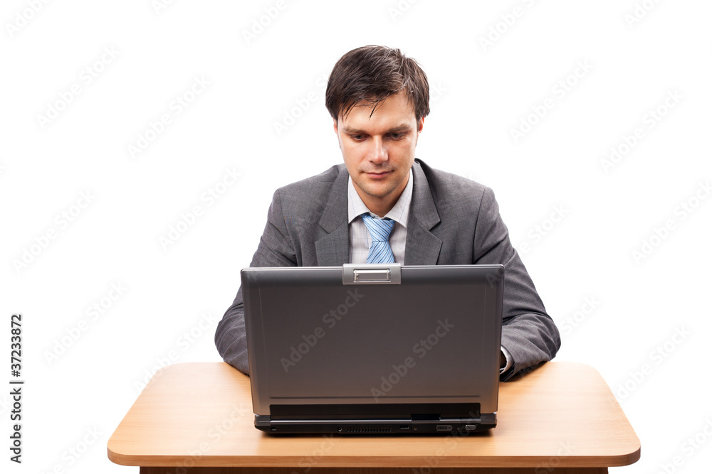Young businessman with laptop at his desk Young businessman with laptop at his desk