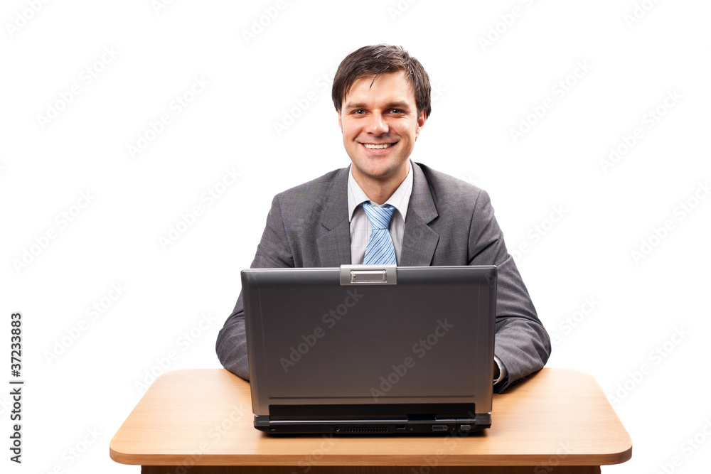 Young businessman with laptop at his desk Young businessman with laptop at his desk