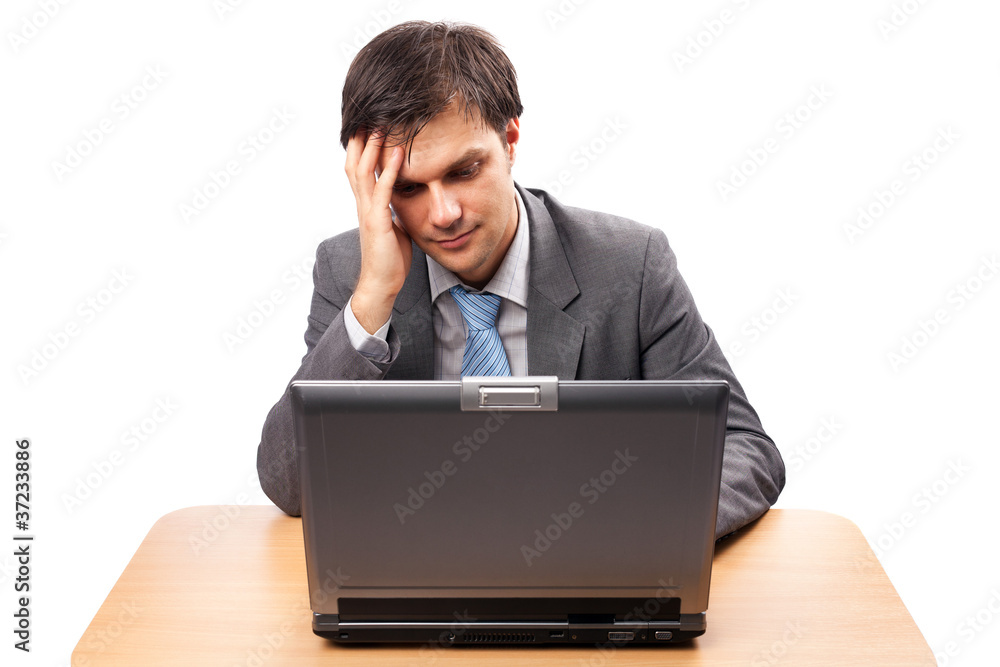 Young businessman with laptop at his desk Young businessman with laptop at his desk