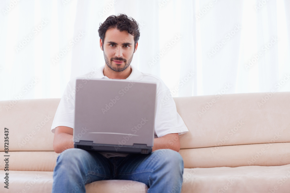Young man using a notebook Young man using a notebook