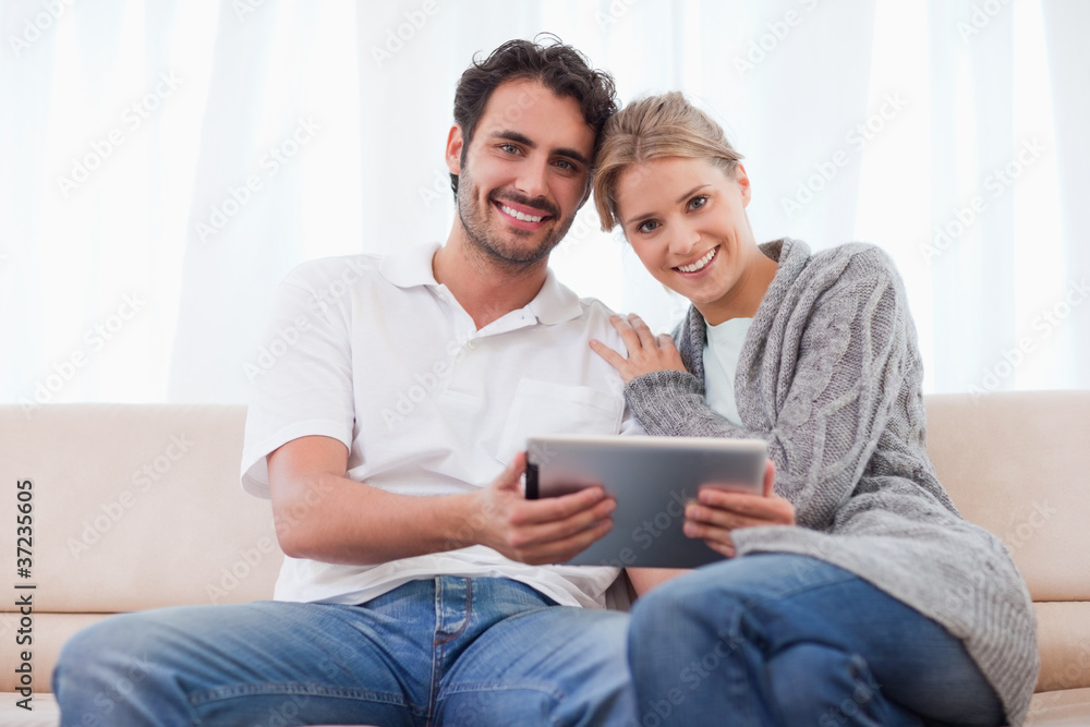 Charming couple using a tablet computer Charming couple using a tablet computer