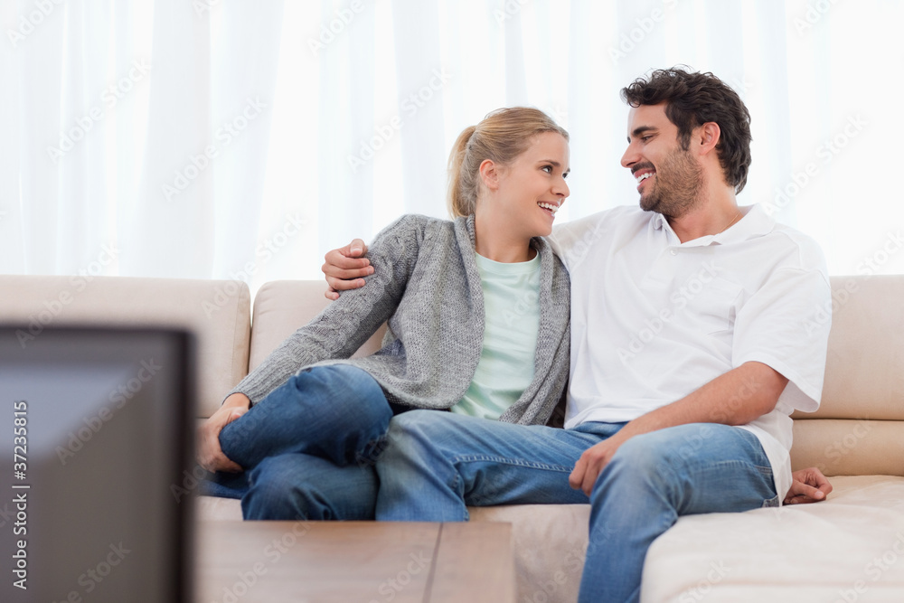 Smiling couple watching TV Smiling couple watching TV
