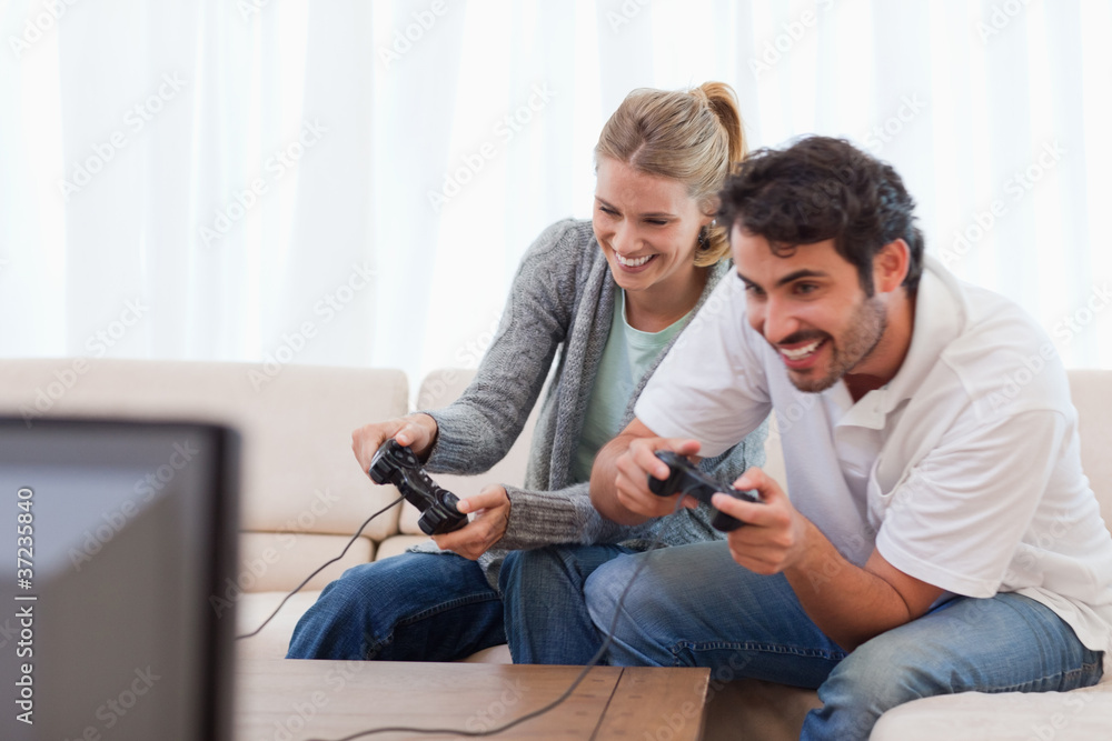 Cheerful couple playing video games Cheerful couple playing video games