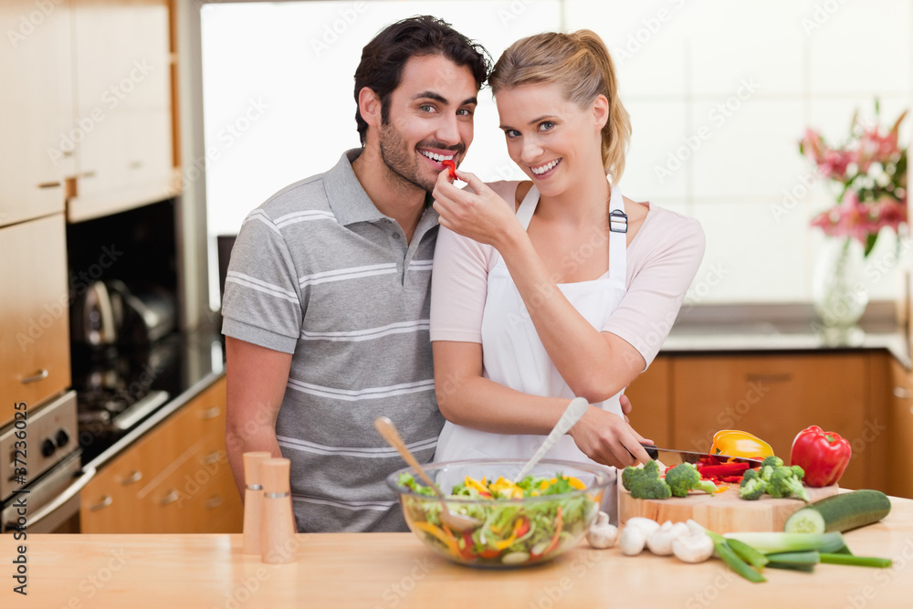 Young couple slicing pepper