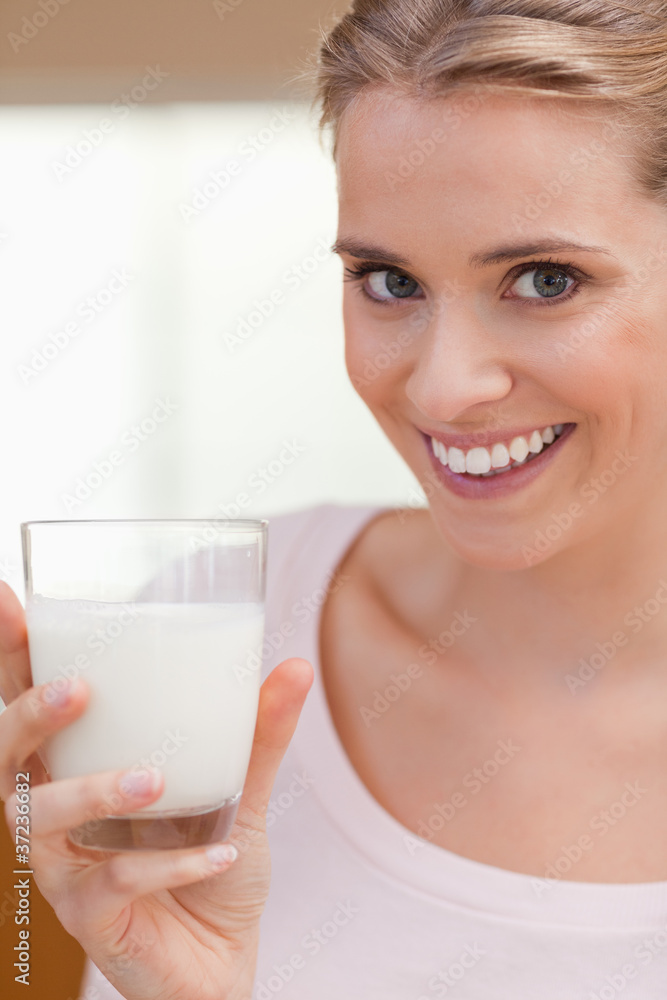 Portrait of a young woman drinking a glass of milk Portrait of a young woman drinking a glass of milk
