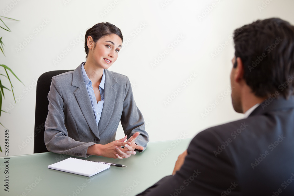 Manager interviewing a good looking applicant Manager interviewing a good looking applicant
