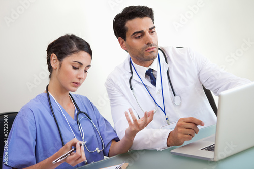 Doctors working with a laptop