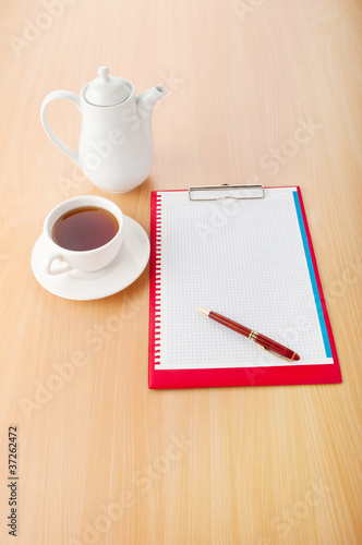 Binder with blank page and tea