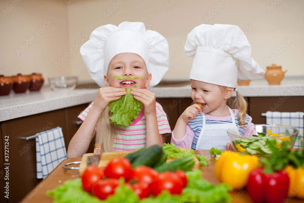 two little girls preparing healthy food and have fun on kitchen two little girls preparing healthy food and have fun on kitchen