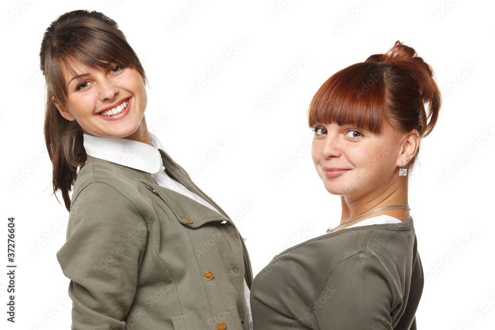 Closeup of two smiling girls standing face to face Closeup of two smiling girls standing face to face