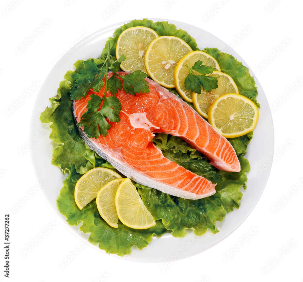 steaks of red fish with a lemon and parsley in dish steaks of red fish with a lemon and parsley in dish