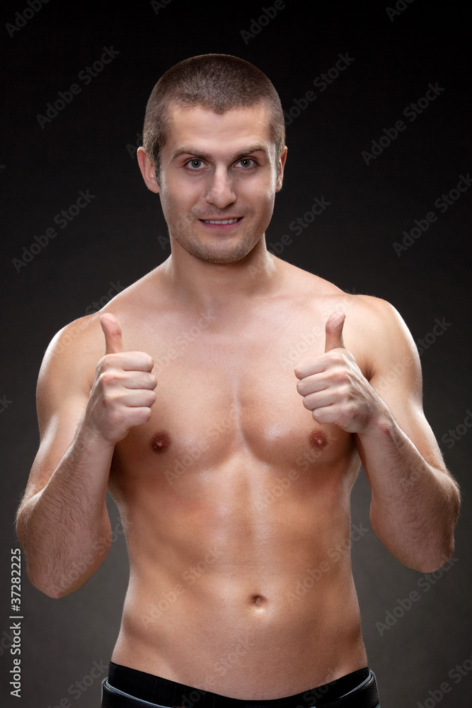 Handsome male shirtless showing thumb up signs