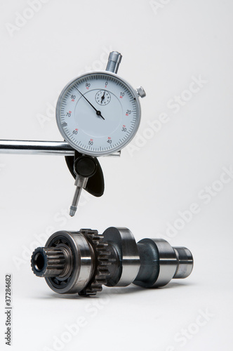 Engineers dial gauge above a camshaft.
