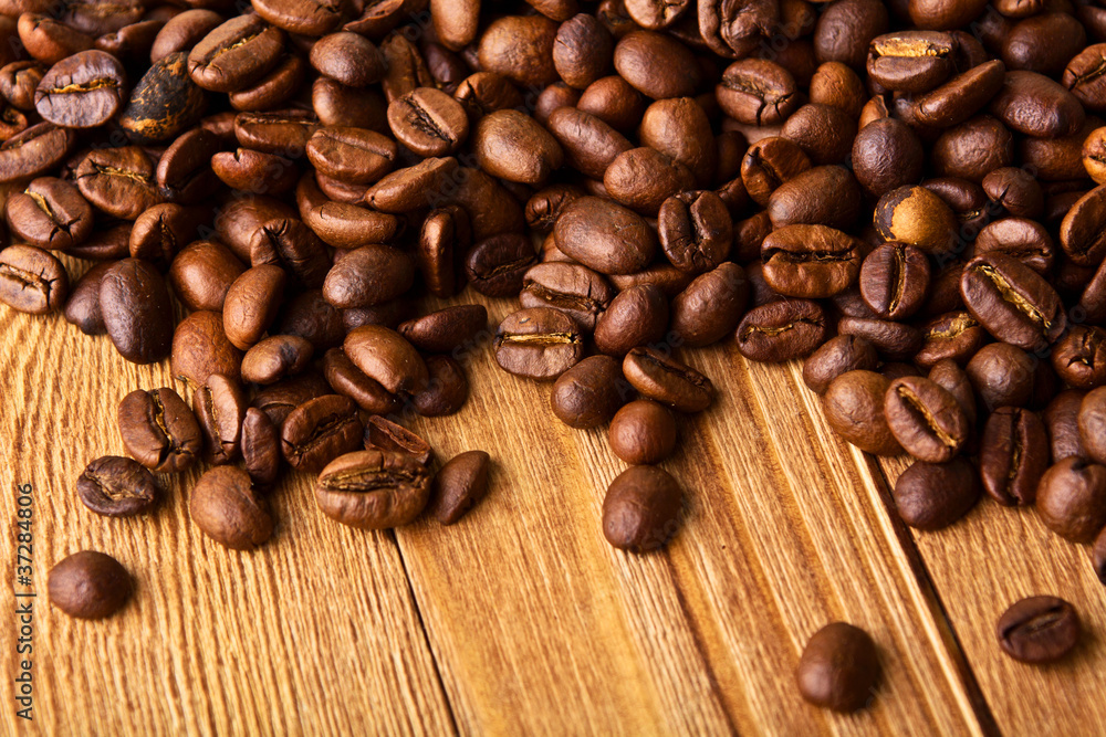 coffee beans on wooden table coffee beans on wooden table