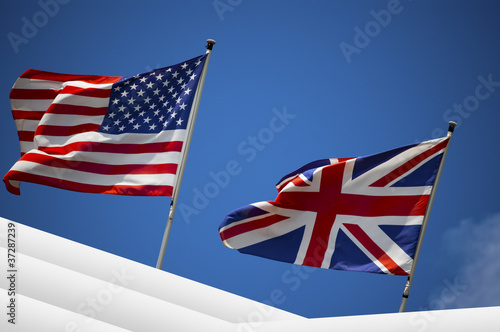 U.S. and UK flags in the blue sky photo
