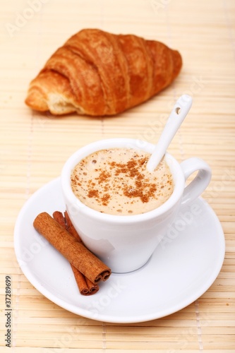 Hot coffee with cinnamon sticks