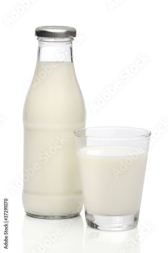 Milk bottle and a glass. With clipping path