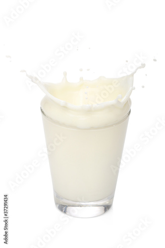 Milk splah on a glass, over white background
