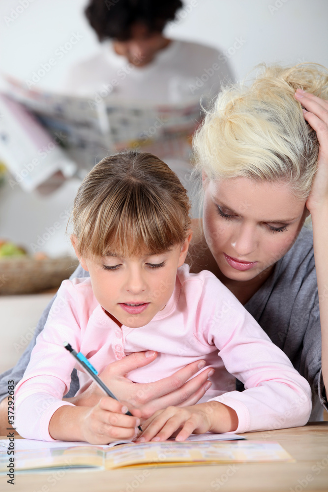 Baby-sitter and little girl doing homework Baby-sitter and little girl doing homework