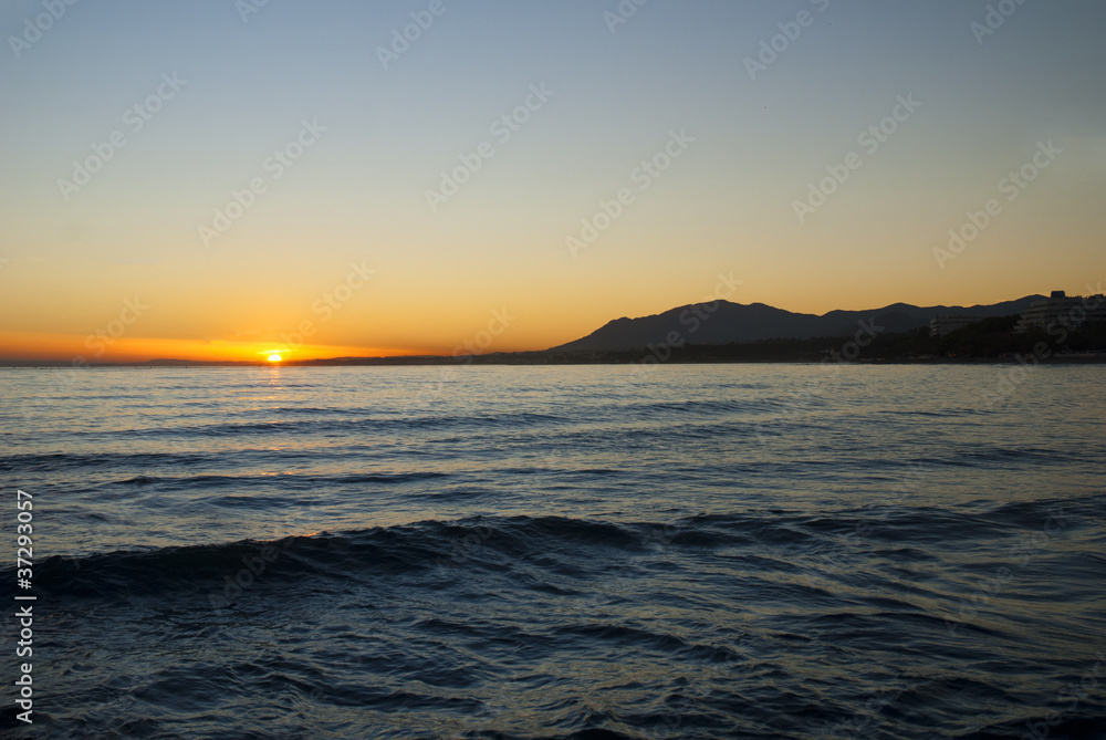 Sunset over beach at Marbella on Costa del Sol Spain
