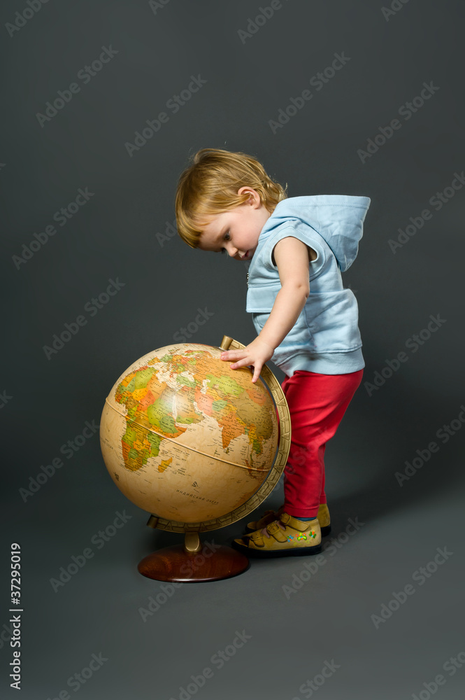 Cute little baby with globe isolated on grey Cute little baby with globe isolated on grey