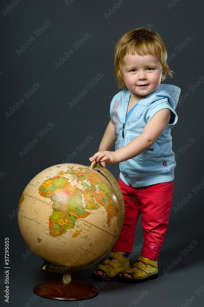 Cute little baby with globe isolated on grey Cute little baby with globe isolated on grey