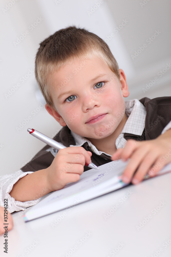 Portrait of little boy doing homework Portrait of little boy doing homework