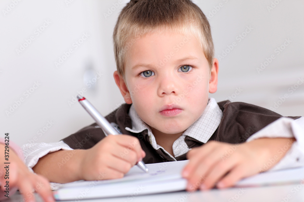 Portrait of little boy doing homework Portrait of little boy doing homework