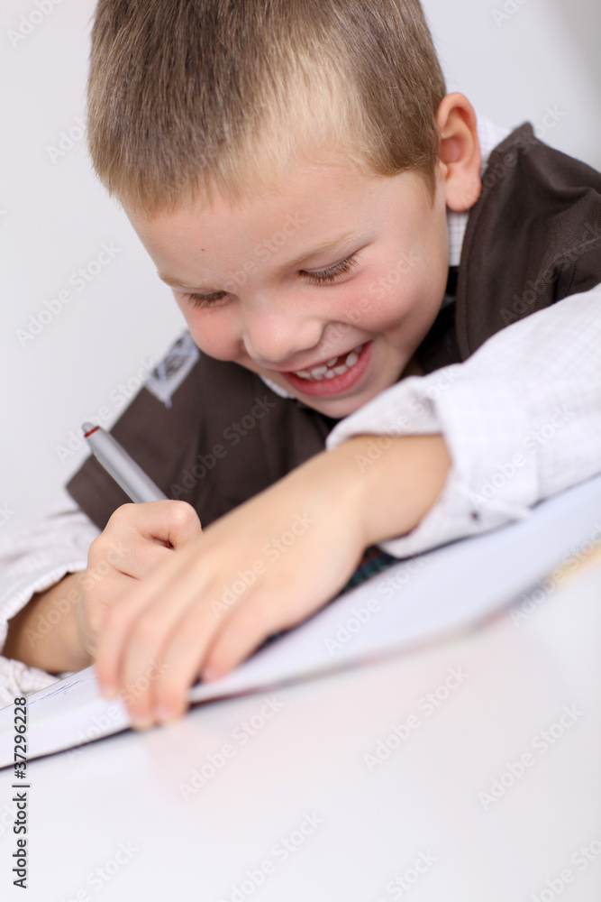 Portrait of little boy doing his homework