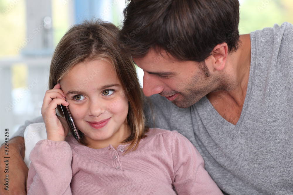 Father and little girl using mobile phone Father and little girl using mobile phone