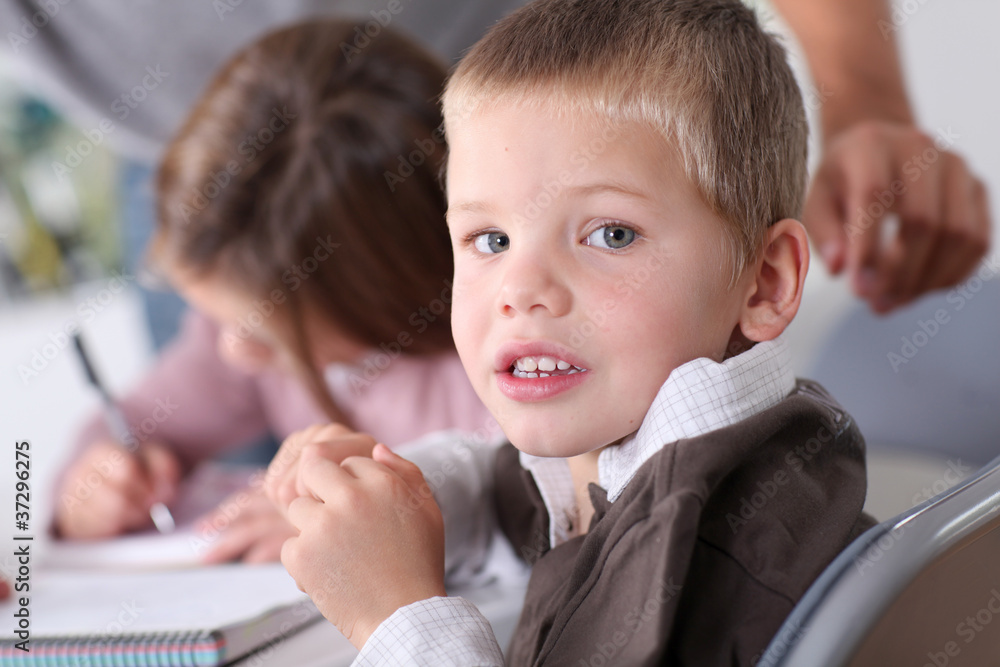 Kids at school doing their homework Kids at school doing their homework