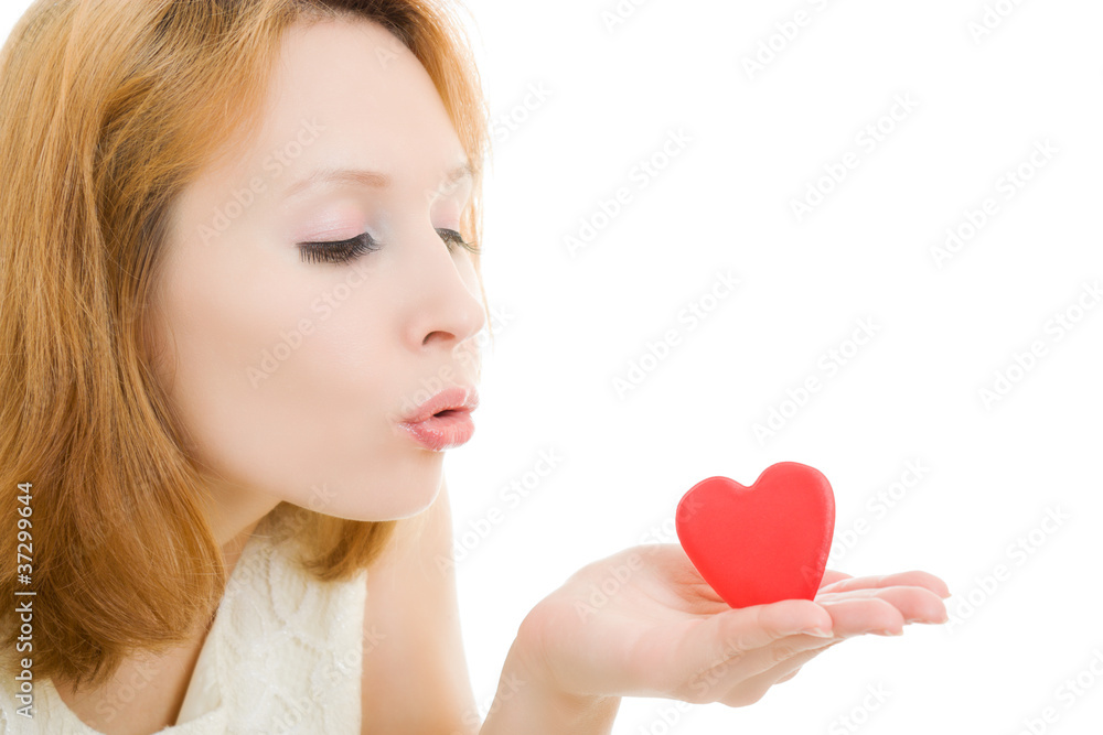 The girl sends an air kiss in the form of heart The girl sends an air kiss in the form of heart