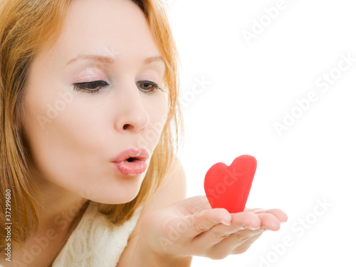 The girl sends an air kiss on a white background.