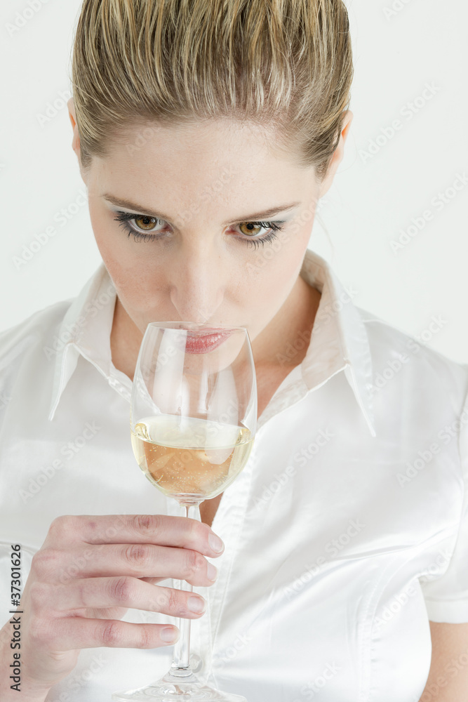 portrait of young woman tasting white wine portrait of young woman tasting white wine