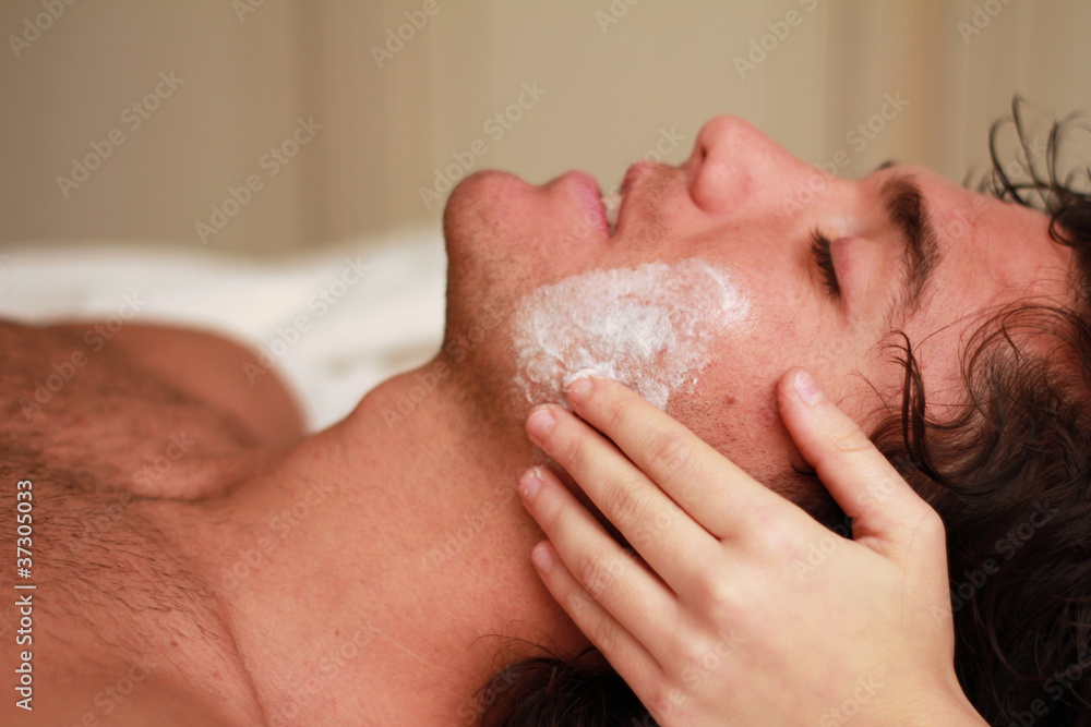 Facial massage to a relaxed young man at the spa Facial massage to a relaxed young man at the spa
