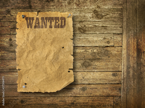 Wild West wanted poster on old wooden wall photo
