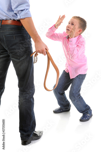 Strict father punishes his son photo