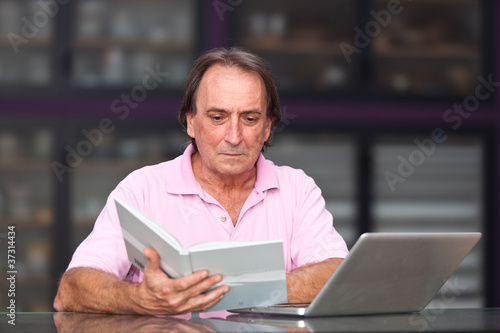 Senior Man with Computer at Office