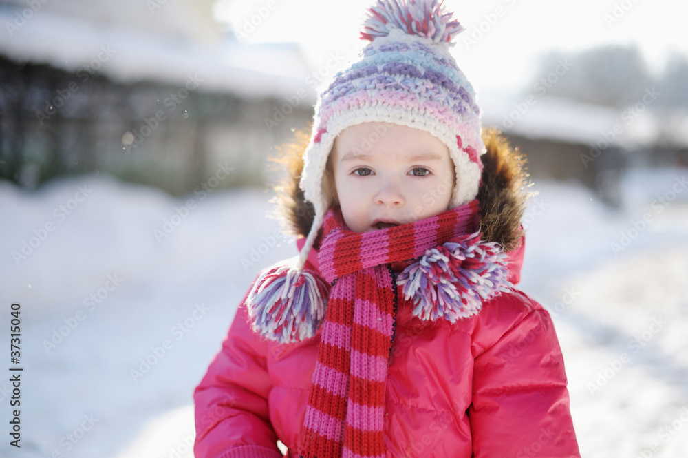 Little girl having fun at winter day