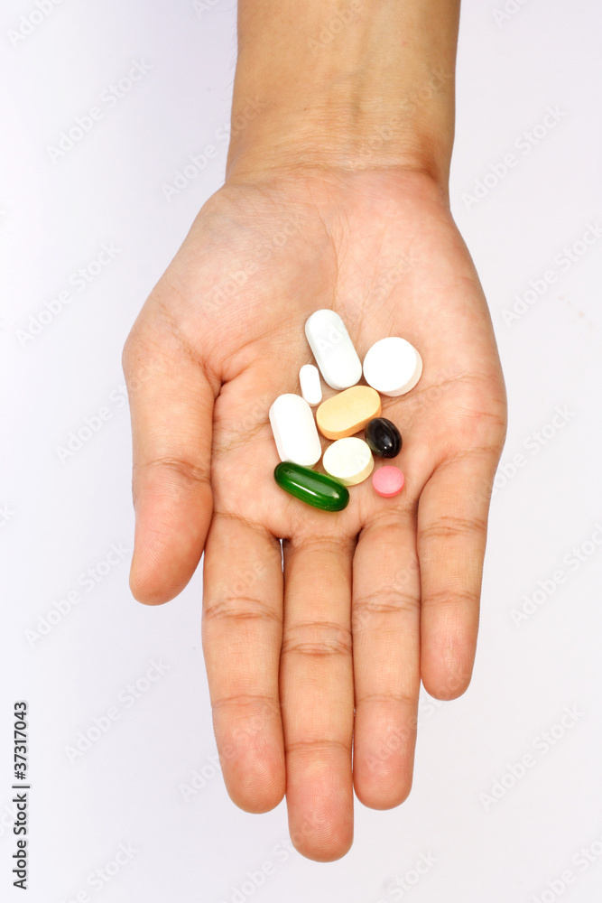 Pills in hand isolated on white Pills in hand isolated on white