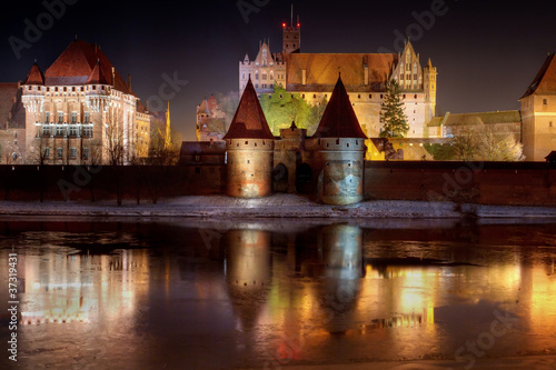 Malbork castle in Poland at night with reflection in Nogat river #37319431