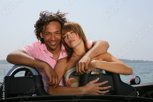 Couple relaxing in convertible sports car © auremar