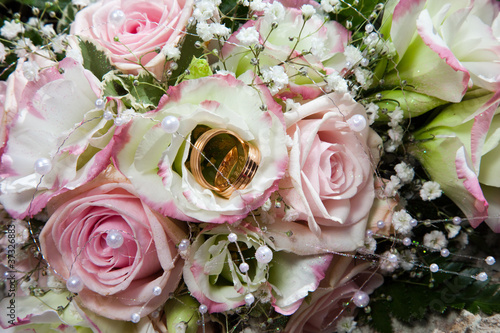 wedding rings on bouquet of bride photo